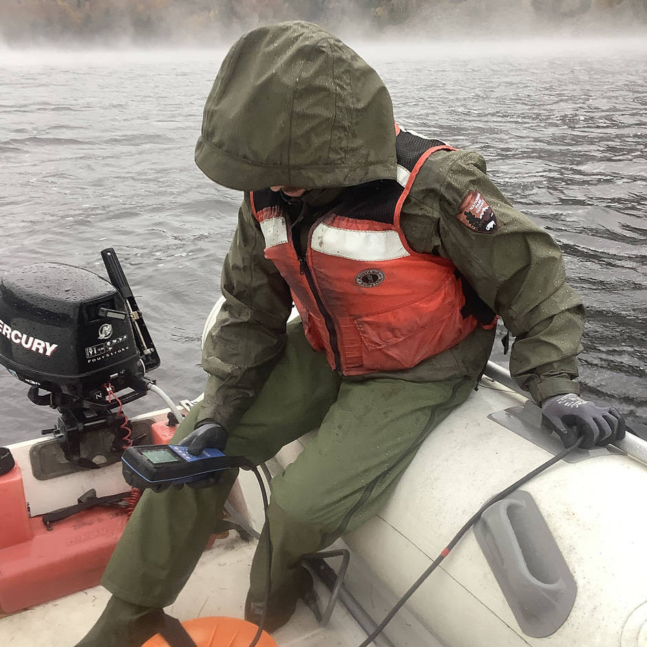 Acadia NP Biological Technician Jake Van Gorder collects a water quality data profile using a YSI EXO1 sonde during a monthly lake monitoring visit.