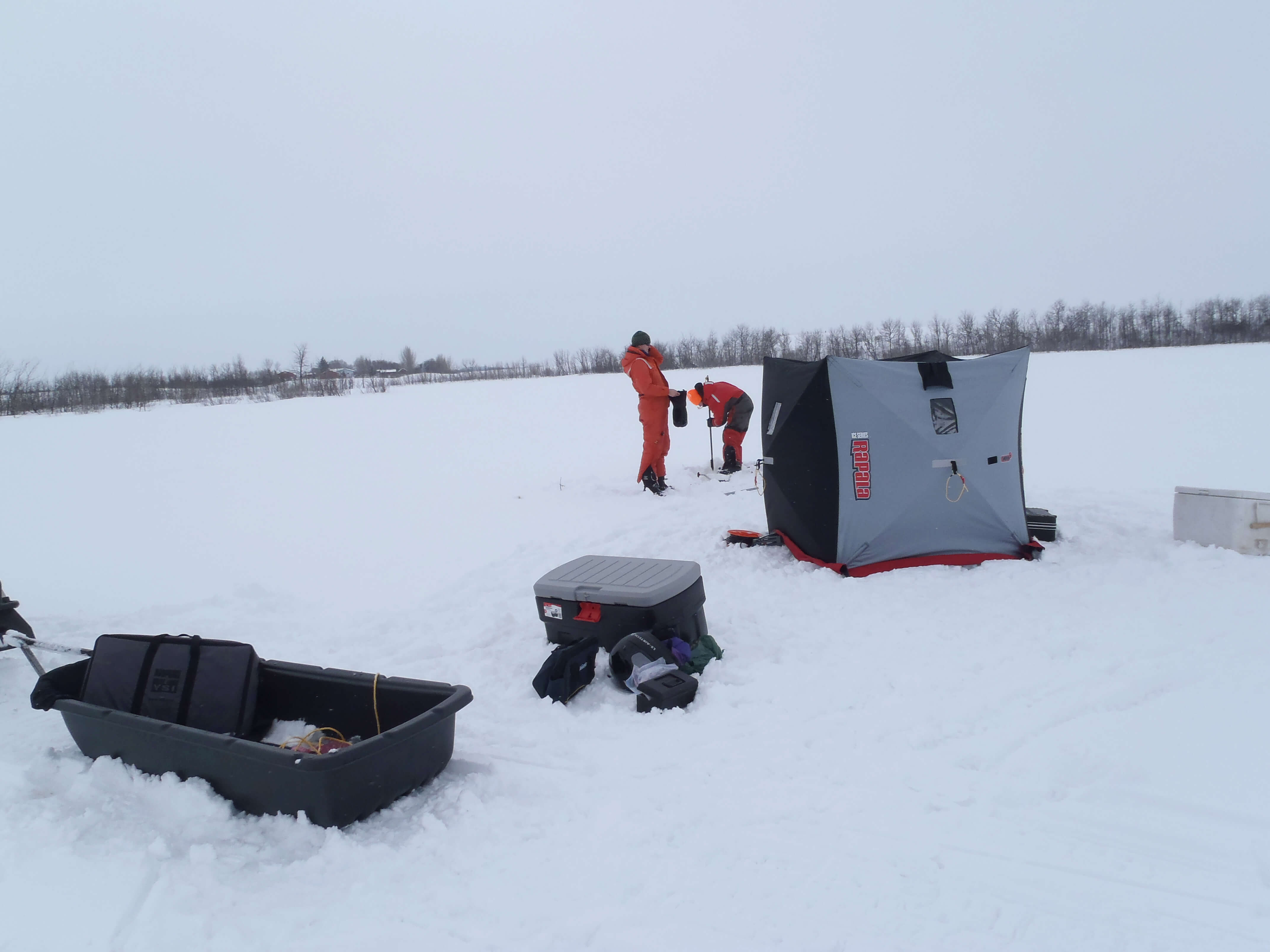 Global Institute for Water Security, University of Saskatchewan staff- Sheena McInnes and Heather Wilson- conduct winter limnology on a Saskatchewan reservoir, Canada at -30oC. (Credit: Rebecca North / MU Limnology Lab, University of Missouri-Columbia)