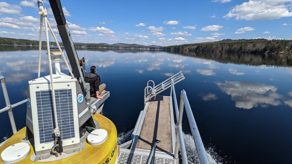 LEA Staff Limnologist Maggie Welch on board buoy boat as it approaches Long Lake, Maine deployment site.