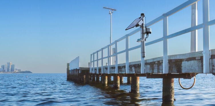 A pole-mounted real-time tide gauge system located on a pier.