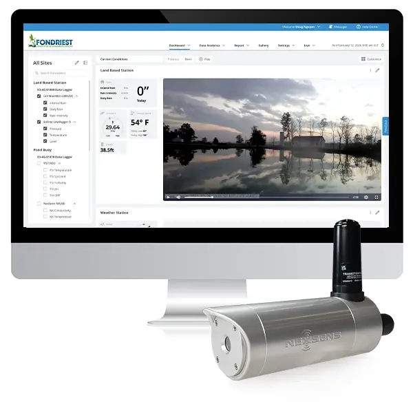 A NexSens EWC Environmental Webcam in front of a computer displaying the WQData LIVE photo/video interface.